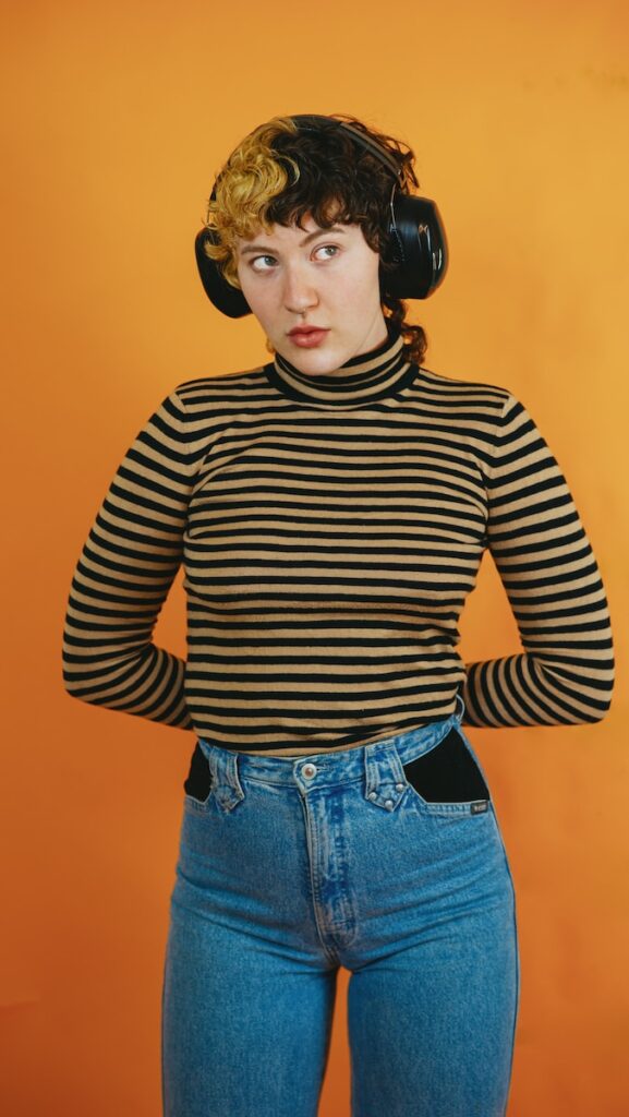 a woman wearing headphones and a striped shirt